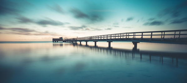 View of bridge over sea against cloudy sky