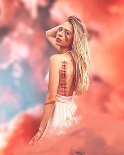 Double exposure of woman and cloudy sky