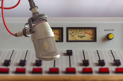 Close-up of microphone over sound recording equipment