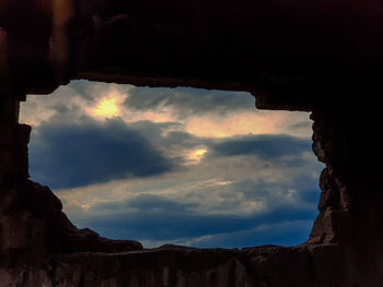 Low angle view of rock formation against sky during sunset