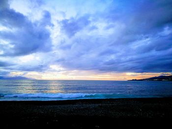 Scenic view of beach against sky during sunset