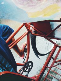 Low section of man riding bicycle on road