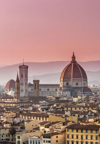 View of buildings in city at sunset