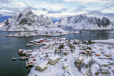 Scenic view of lake and snowcapped mountains against sky