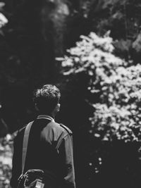 Rear view of man standing in forest