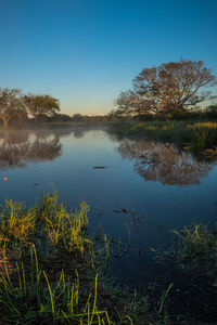 Scenic view of lake against blue sky