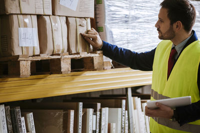 Man in warehouse supervising stock