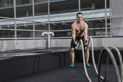 Man training at rooftop gym in bangkok