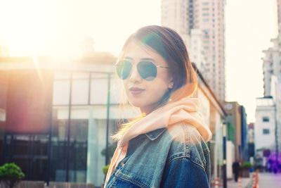 Portrait of woman standing in front of building