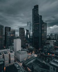 High angle view of illuminated buildings against sky at dusk