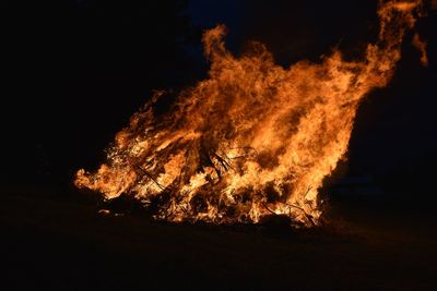 Close-up of bonfire against sky at night