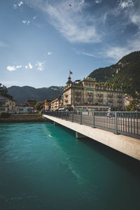 View of swimming pool by buildings in city