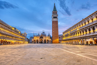 An empty st marks square in venice with the bell tower and the cathedral at dawn