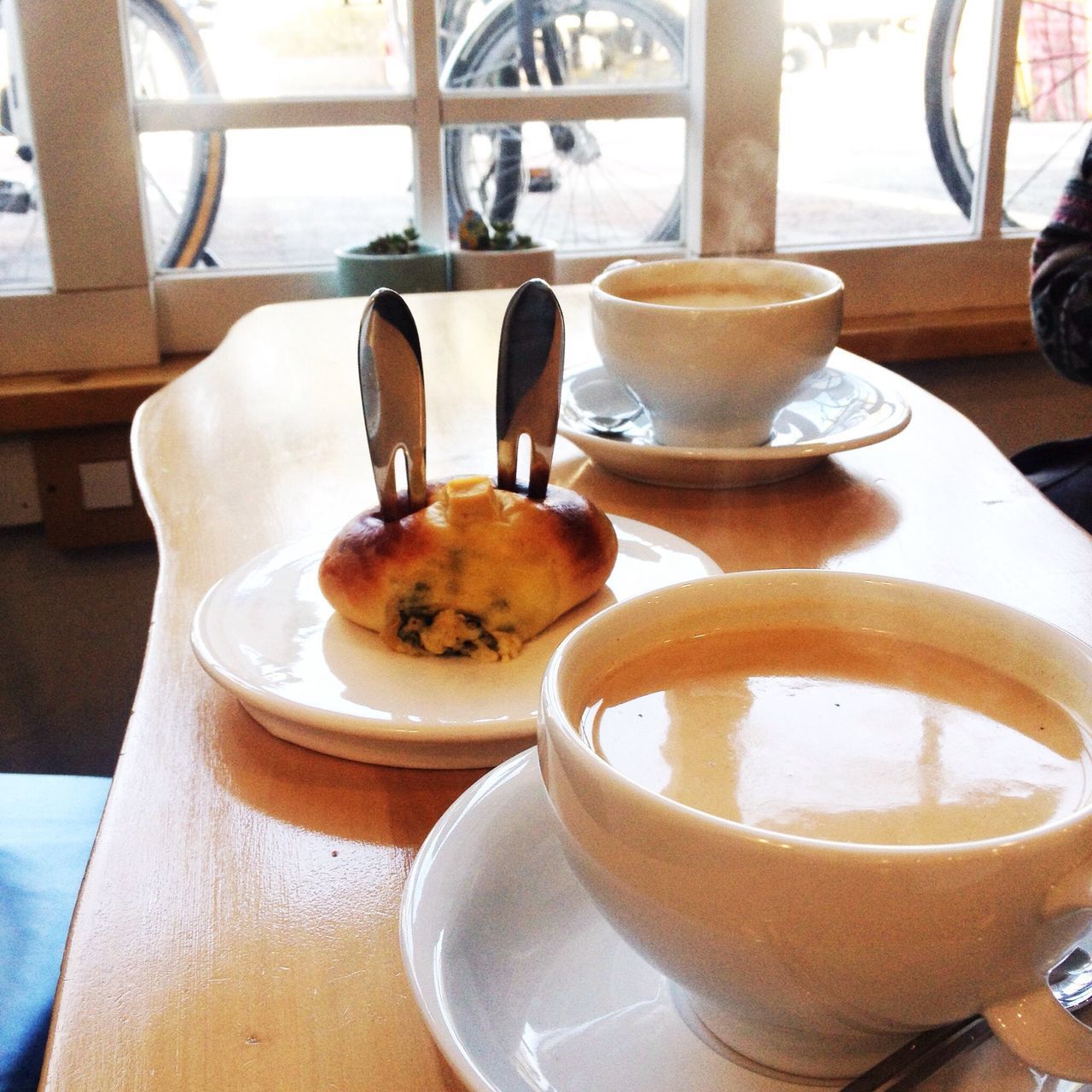 food and drink, drink, indoors, coffee cup, table, refreshment, coffee - drink, saucer, freshness, coffee, still life, frothy drink, cup, close-up, spoon, cafe, cappuccino, froth art, day, high angle view