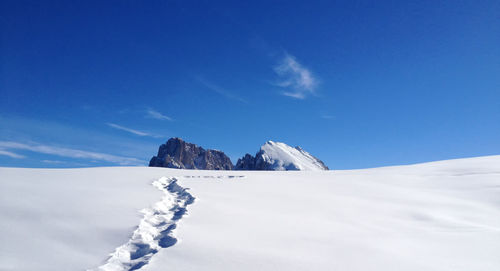 Snow covered mountain against blue sky