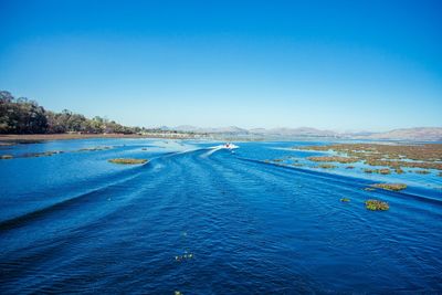 Scenic view of sea against clear blue sky