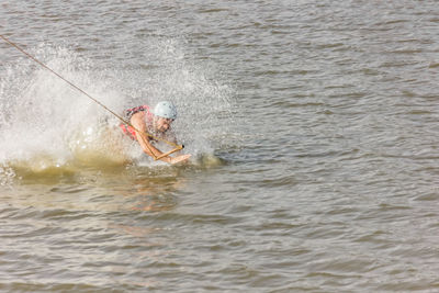 Man kite boarding in river