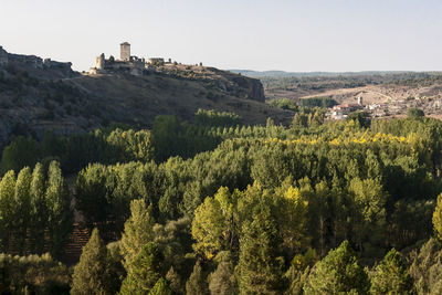 Panoramic view of trees and buildings against clear sky