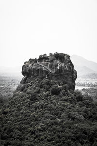 Rock formations on landscape against clear sky