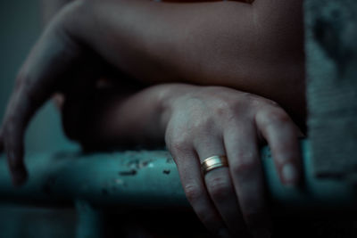 Close-up of hands on railing