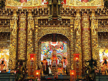 Illuminated statue of building at temple