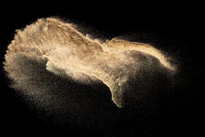 Close-up of water splashing against black background