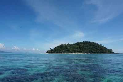 Scenic view of ocean and island against sky