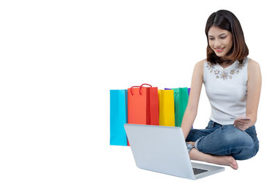 Young woman smiling against white background