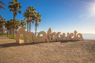 Scenic view of beach against clear blue sky