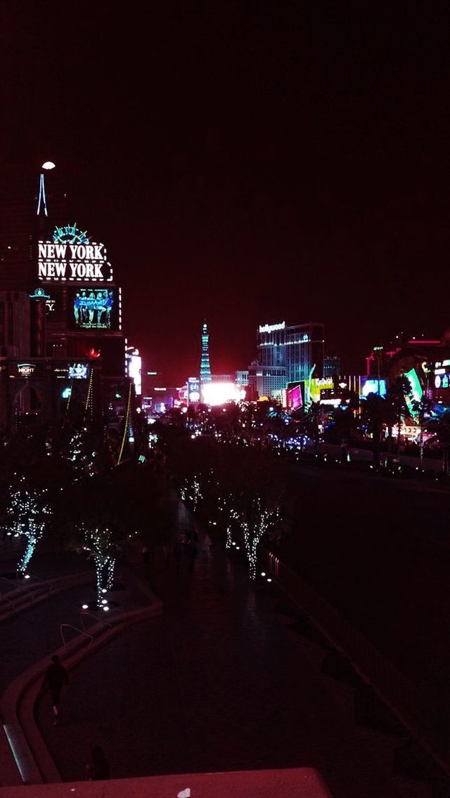 illuminated, night, building exterior, city, architecture, built structure, city life, street, clear sky, copy space, cityscape, city street, street light, lighting equipment, transportation, sky, outdoors, road, light - natural phenomenon