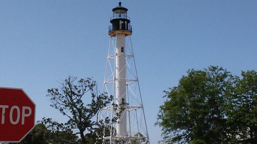 Low angle view of communications tower against clear blue sky