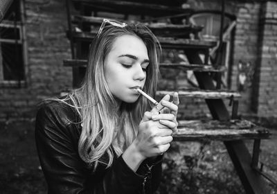 Young woman smoking outdoors