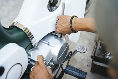 Cropped hand of mechanic working in garage