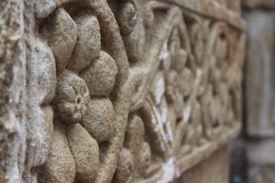 Close-up of statue against stone wall