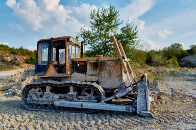 Abandoned truck on field against sky