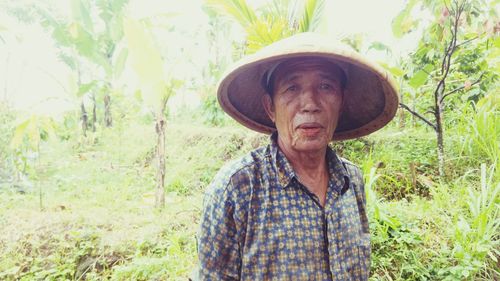 Portrait of man wearing hat standing in farm