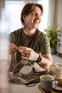 Side view of young woman using mobile phone