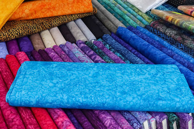 Detailed close up view on samples of cloth and fabrics in different colors found at a fabrics market