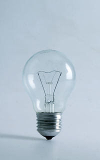 Close-up of light bulb against white background