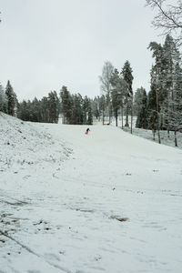 Scenic view of snow covered field against sky