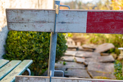 Close-up of rusty metal hanging on railing