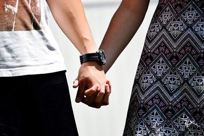 Close-up of couple holding hands