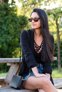 Portrait of young woman sitting outdoors