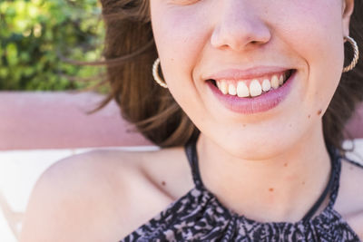 Close-up midsection of smiling young woman