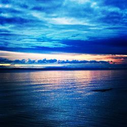 Scenic view of sea against sky at sunset