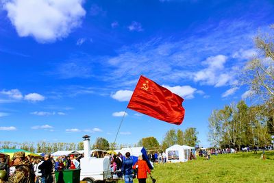 People on beach against blue sky