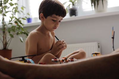 Boy looking at camera at home