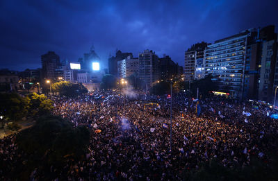 High angle view of soccer fans celebrating on street at night