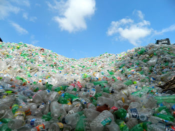 Heap of plastic bottles against sky