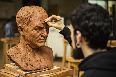 Sculptor finishing a clay head